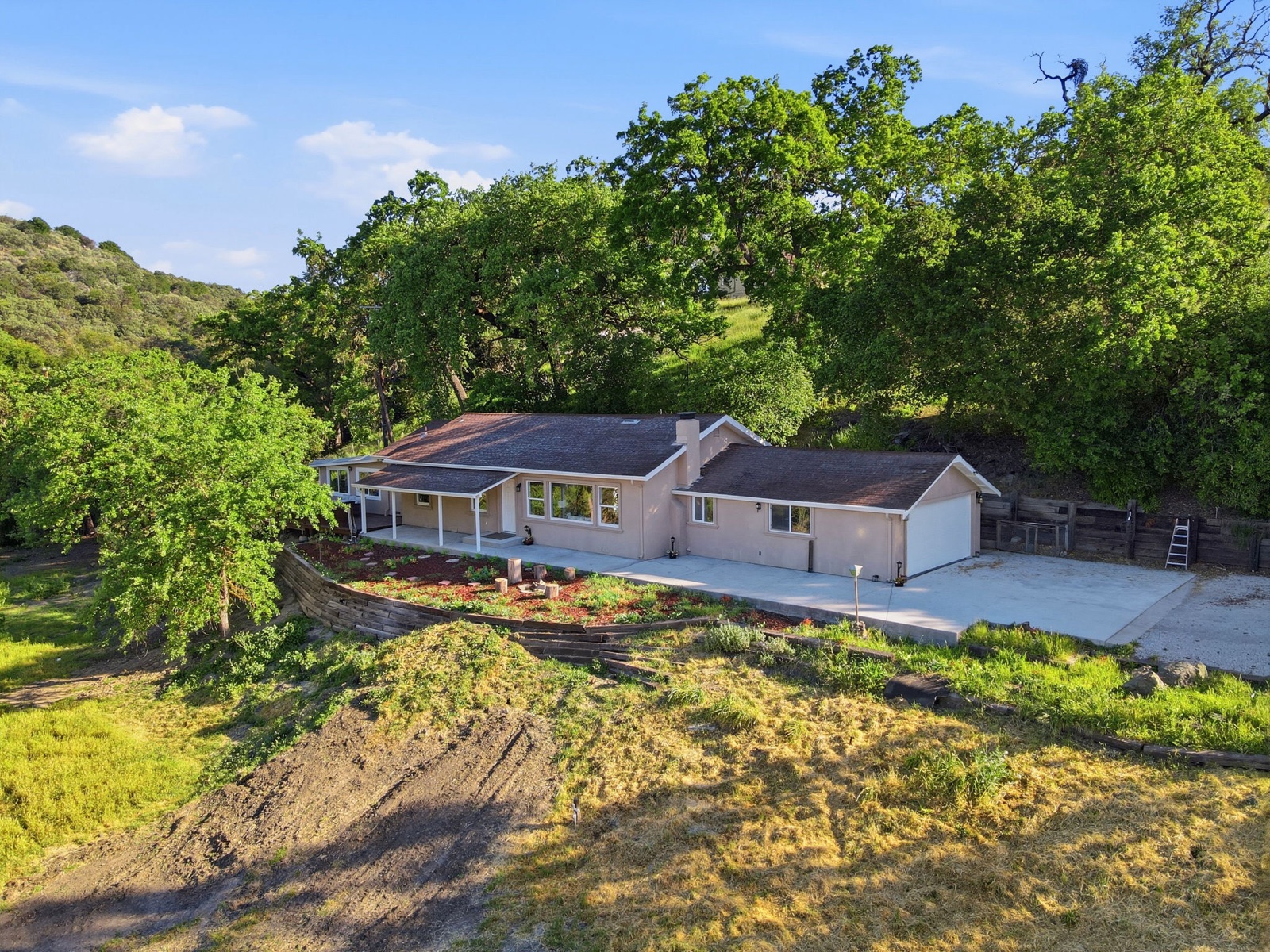Aerial view of the main residence, garage, and driveway at 22000 Fortini Road